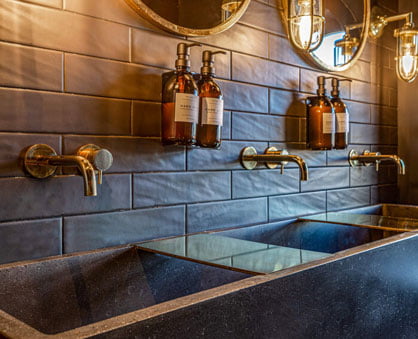 Custom concrete troughs with brass accessories